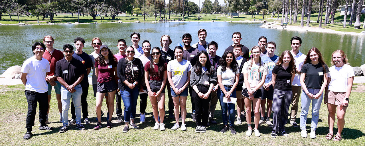 Group photo of interns at a park