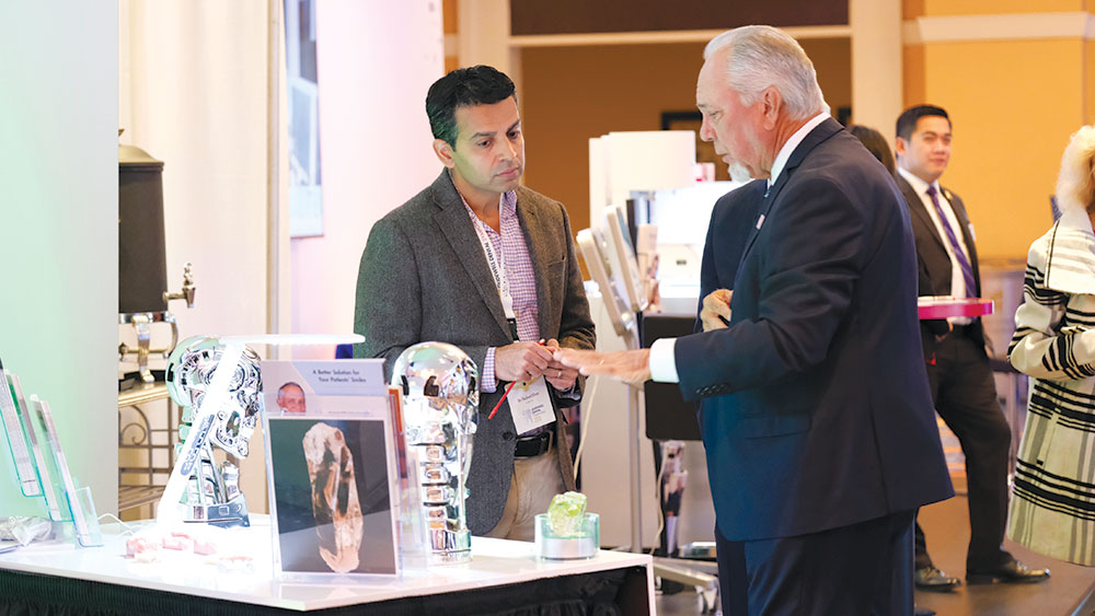 An attendee (left) met with Jim Glidewell, president and CEO of Glidewell Dental