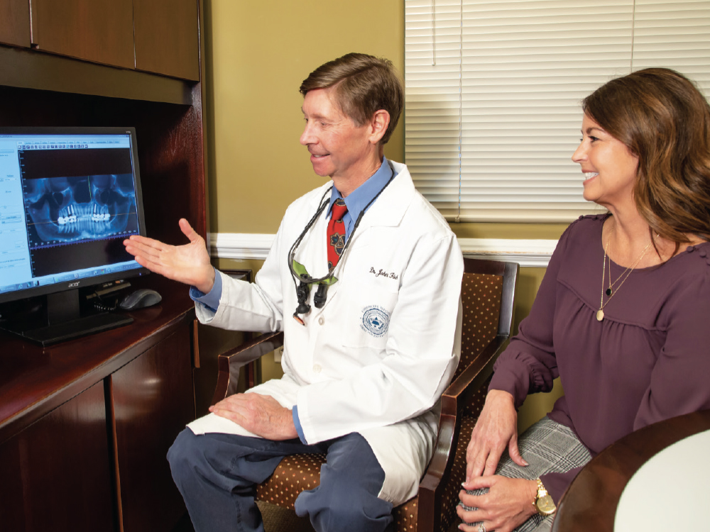 Dr. John Fish showing patient implant treatment options