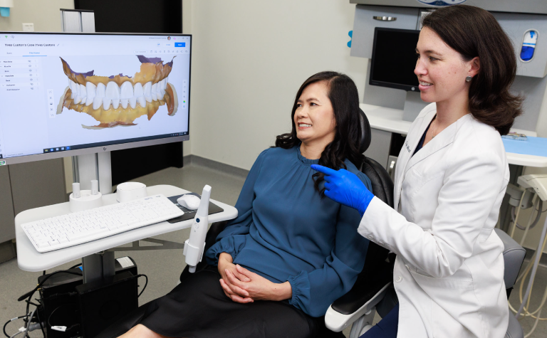 Dr. Manalilli with patient looking at scan Dr. Manalilli with patient looking at scan