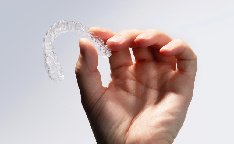 Clear Aligners held in hand Clear Aligners held in hand